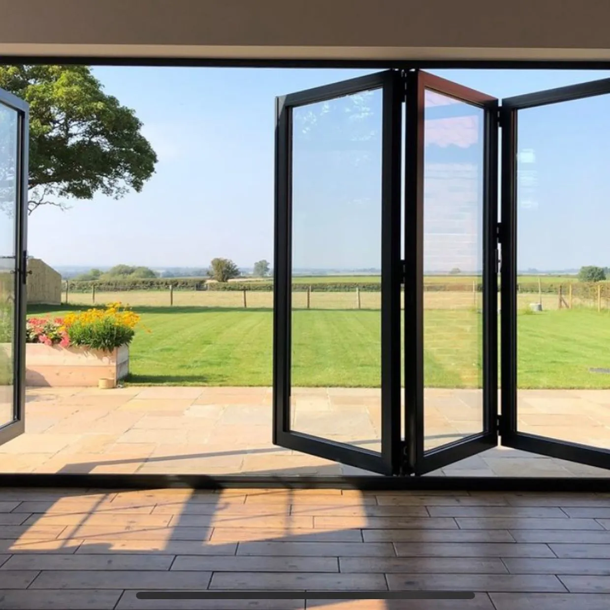 Black bifold doors leading to garden